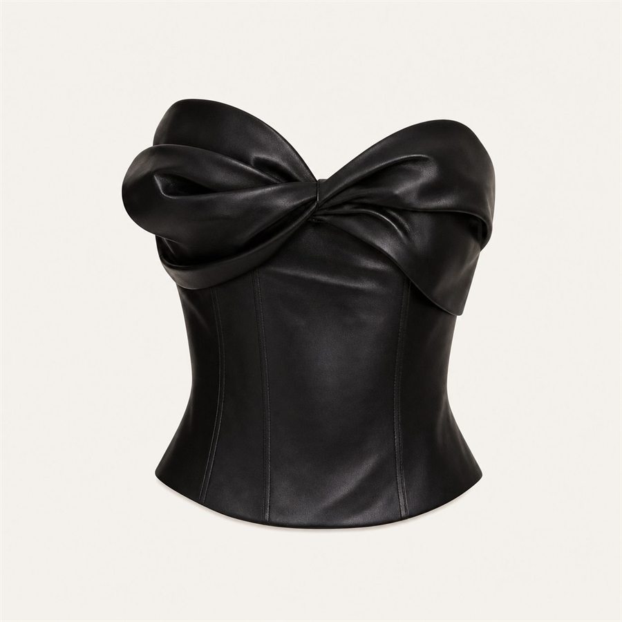 Black sculptural bow bustier top on a warm off-white background