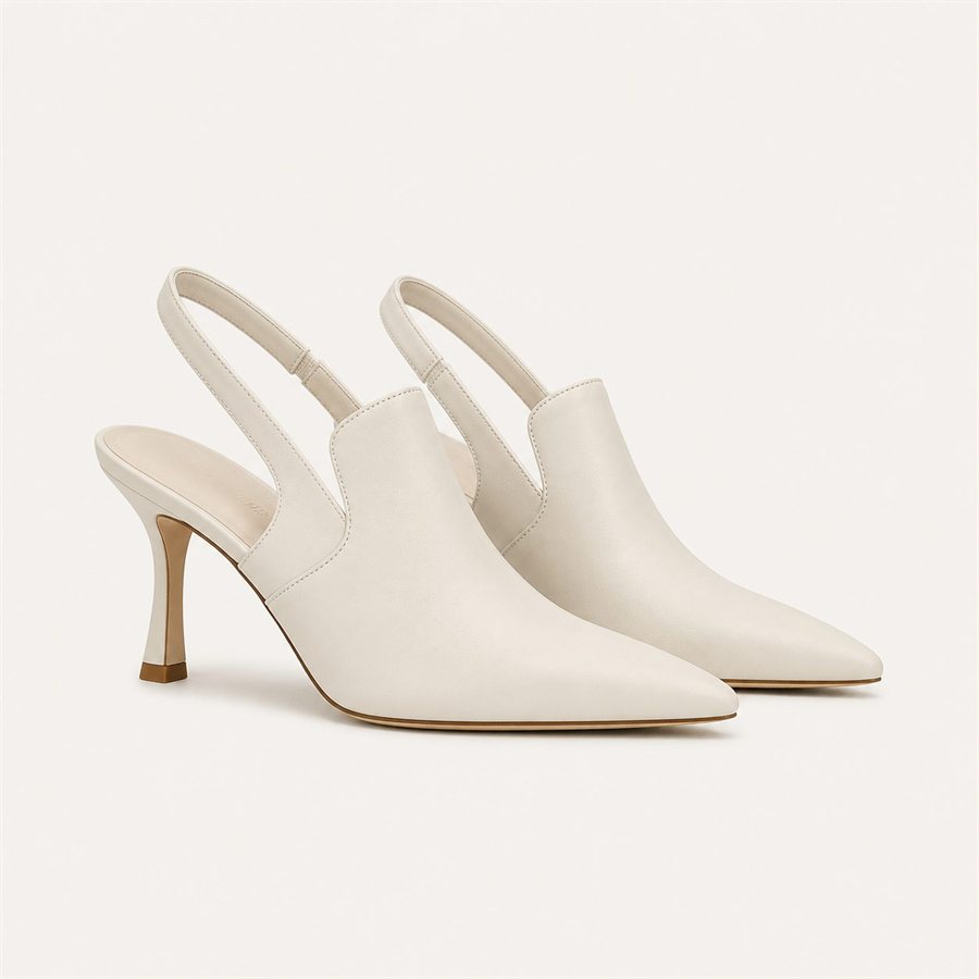 Ivory leather slingback heels on a warm off-white background
